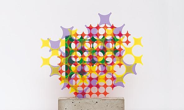 sculpture of colourful shapes on a concrete brick base